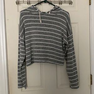 Gray hoodie with white stripes and drawstrings.